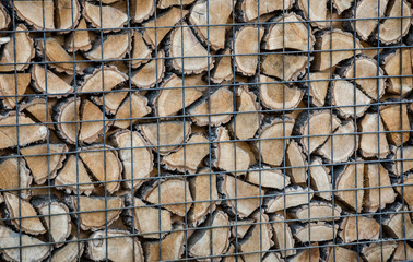 firewood beautifully folded behind the grid