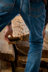 Carpenter steps over a wooden board