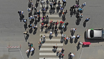 Naklejka premium Aerial. People crowd on pedestrian crosswalk. Top view.