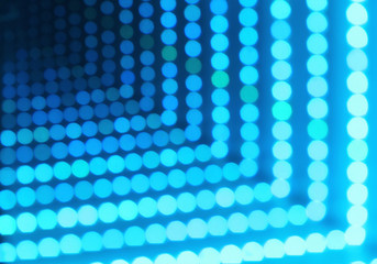 Abstract futuristic background of glowing dotted neon lights, perspective view