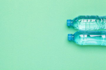 Blank water bottle on blue background top view