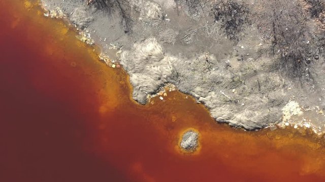 Above red acidic mine drainage and coast 4K aerial video