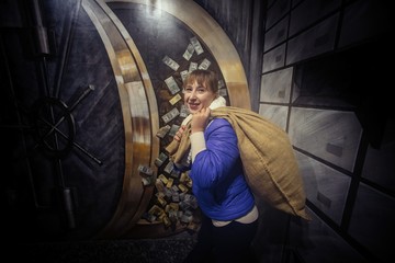 Fototapeta na wymiar Bank robber woman with bag of money finance business