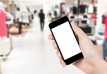 Smart phone with white screen in hand on blurred in shopping mall background