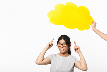 Asian beautiful young woman posing isolated over white wall background near speech bubble thoughts.