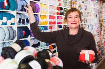 Fototapeta na wymiar Female client is buying colorful yarn for their hobby