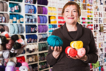 Woman holding colorful knitting yarns