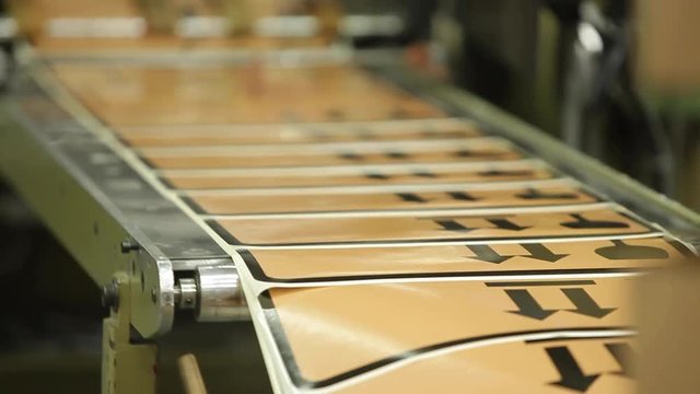 Label Printing Rolls with High speed labeling machine in industrial factory, sticker on product in manufacture. Flexible packaging. Close Up, direction arrows.