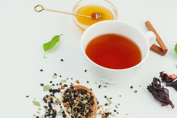  layout made of cup of black tea and leaves on a white background. Top view