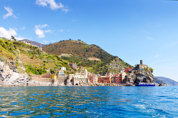 Fototapeta premium Liguria, Italy coastline of Riviera with colorful houses on sunny warm day. Monterosso al Mare, Vernazza, Corniglia, Manarola and Riomaggiore, Cinque Terre National Park UNESCO World Heritage