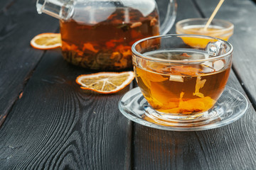 Cup of tea and tea leaves on wooden table