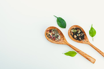 leaf  tea in a wooden spoon isolated on white background