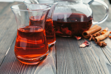 A cup with tea and teapot stand on table top view