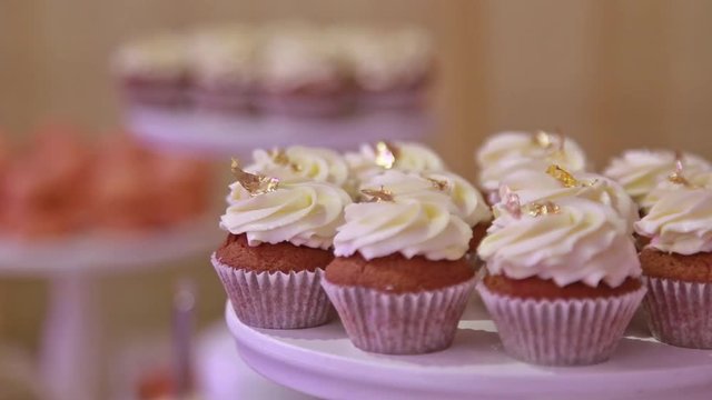Woman waitress serving banquet table, exposes fresh chic cuocakes , hands close-up.