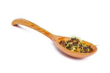 Dried tea on a wooden spoon, isolated on white