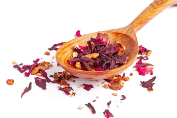 Dried tea on a wooden spoon, isolated on white