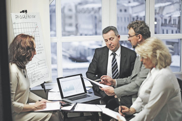 group of business people discussing an important document.