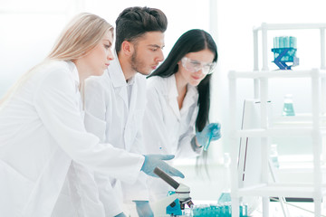 group of young scientist discussing something in their lab