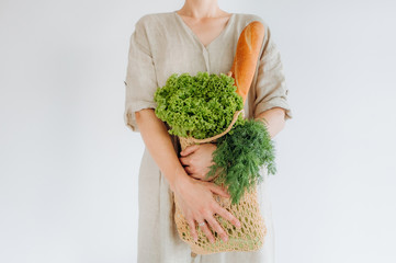 woman hugs food greens shopping bag mesh