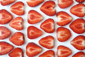 Strawberry slice red background texture. Top view. Concept of summer eco food