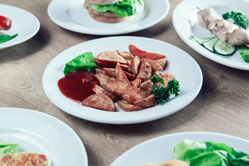 Plate with delicious baked potato slices and sauce