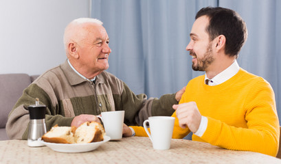 Elderly father and son breakfast