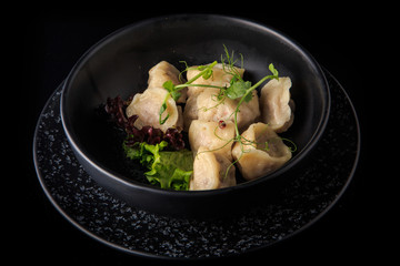 freshly boiled meat dumplings served with salad in bowl