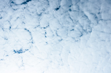 Background texture of Stratocumulus Cloud formations on a blue sky. 