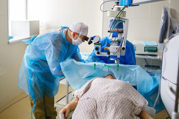 Two ophthalmologist perform an operation in the operating room, delicate work with the eyes, eye...