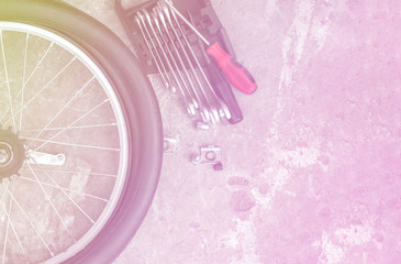 Close up of bicycle rear wheel and hub with tools. colorful light