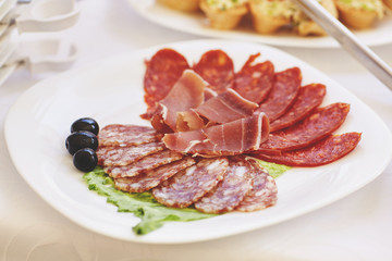 slices of salami and meat on the festival table