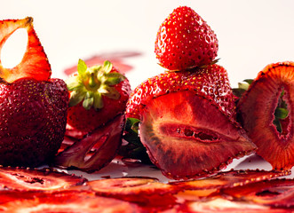 fresh berries and strawberry chips on a white background