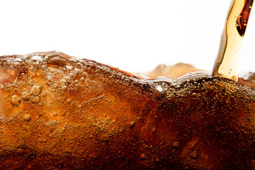 Close up cola pouring with ice and bubble in glass on white background cold drink beverage