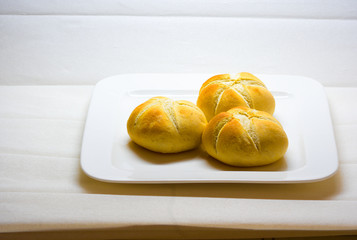 plate with buns of white bread with faded background