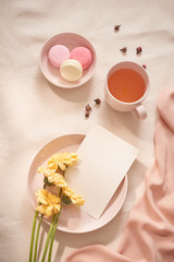 Tea cup with Rose tea and fresh  flower and macarons on white background