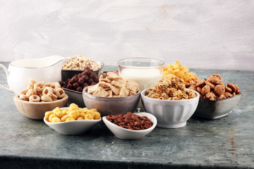 Cereal. Bowls of various cereals and milk for breakfast. Muesli with kids cereals.
