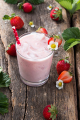 Fresh milk, strawberry on wooden table, assorted protein cocktails with fresh fruits. Natural background.