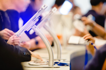 tablet at register counter for registration in to seminar or meeting with blurry people background....