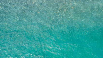 Aerial view of sea surface. Top view of transparent turquoise ocean water surface.