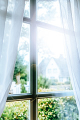 Evening sun shining through a traditional Frisian window with white drapes