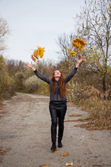 young redhead woman in autumn park. autumn yellow leaves