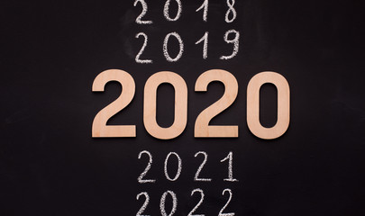 Wooden 2020 on time line on black background