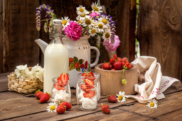 strawberry with cream cheese in glass jars, healthy summer food in a rustic style