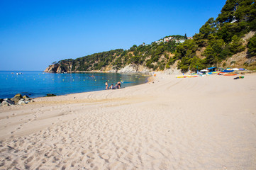 Costa Brava beach. Blue clean water and beautiful beach. Turquoise bay with a crystal water. Summer vacation. Nature in Spain 