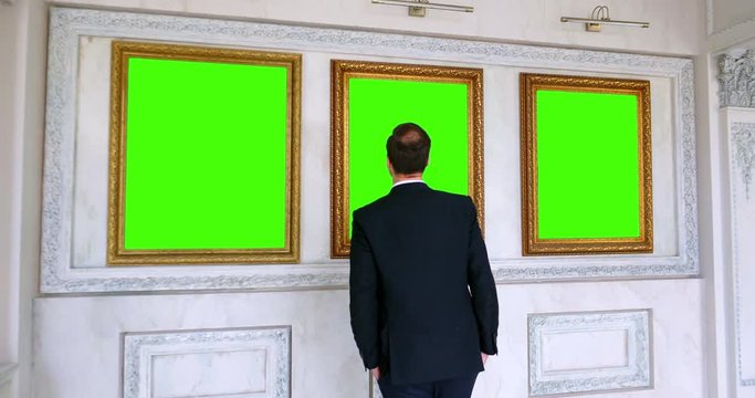 Back view of man observing painting in art gallery - Image