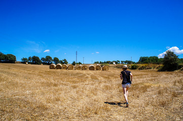 Countryside in Spain. Catalan village. Haystacks and blue summer sky. Tourist in the village. Fun and travel in Europe