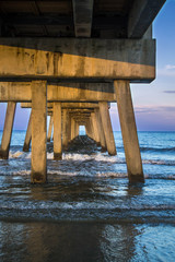 Crashing waves under fishing pier