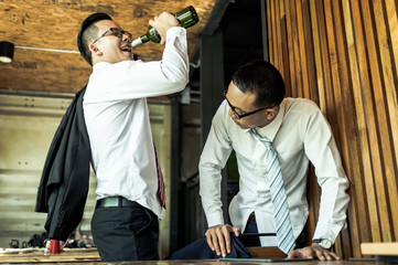 two businessman drunk and laughing after drinking hard in restaurant to celebrate the success of work. concept of winner and business successful