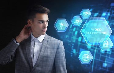 The concept of business, technology, the Internet and the network. A young entrepreneur working on a virtual screen of the future and sees the inscription: Video marketing