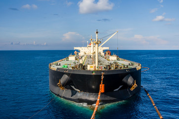 Oil tanker is transferring supply to the oil vessel.